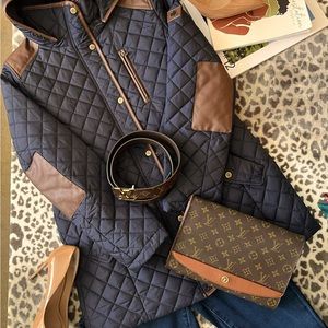 Dark blue mid length jacket with brown leather trimmings with designer lining.